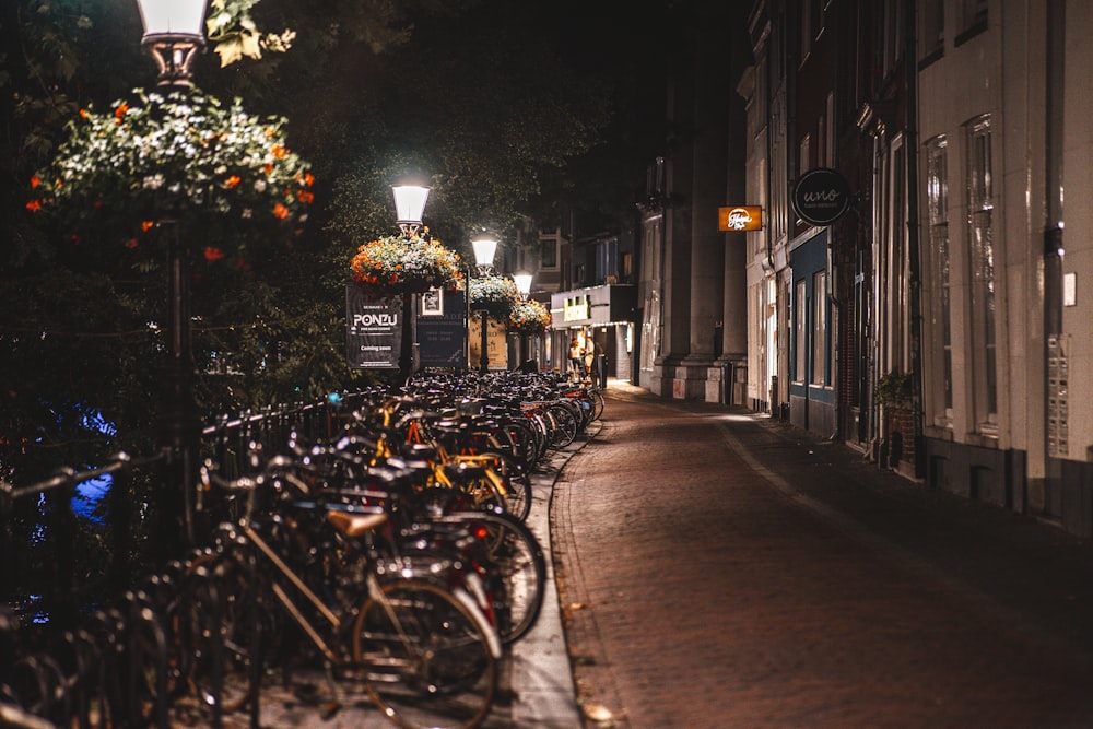 a row of bikes parked on the side of a street