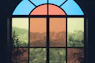 a view of a city through a stained glass window