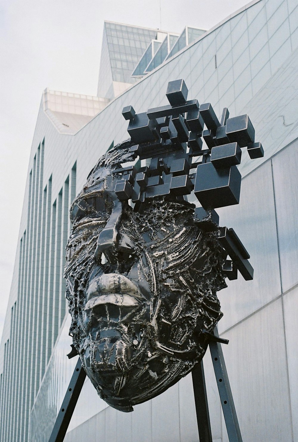a sculpture of a human head with cubes on it