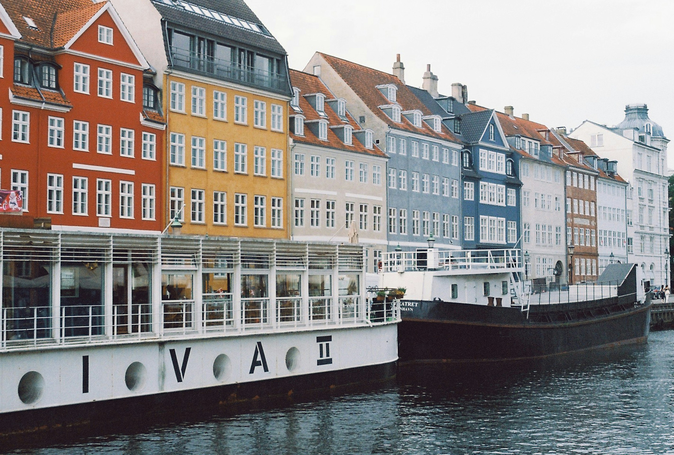 a row of buildings next to a body of water