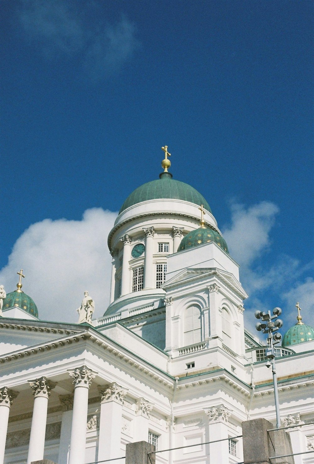 a large white building with a green dome