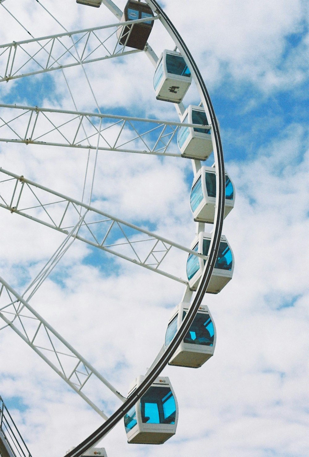 a ferris wheel is shown against a cloudy blue sky
