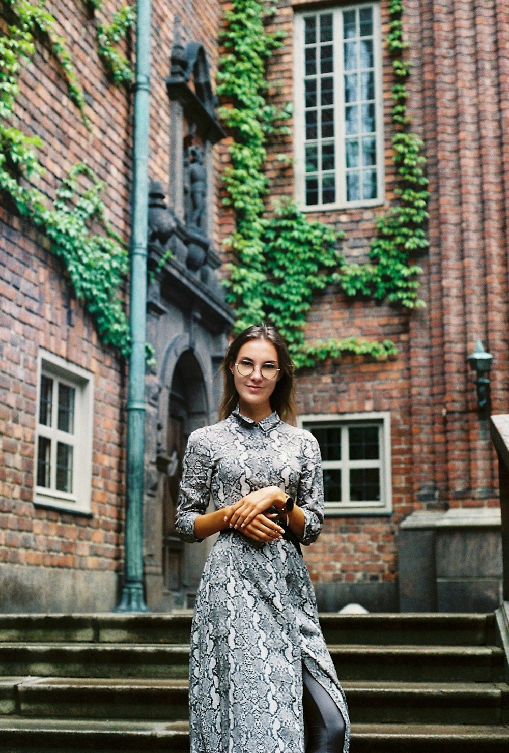 a woman standing on steps in front of a building