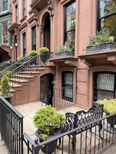 Friendly carpet cleaning team smiling outside a New York brownstone