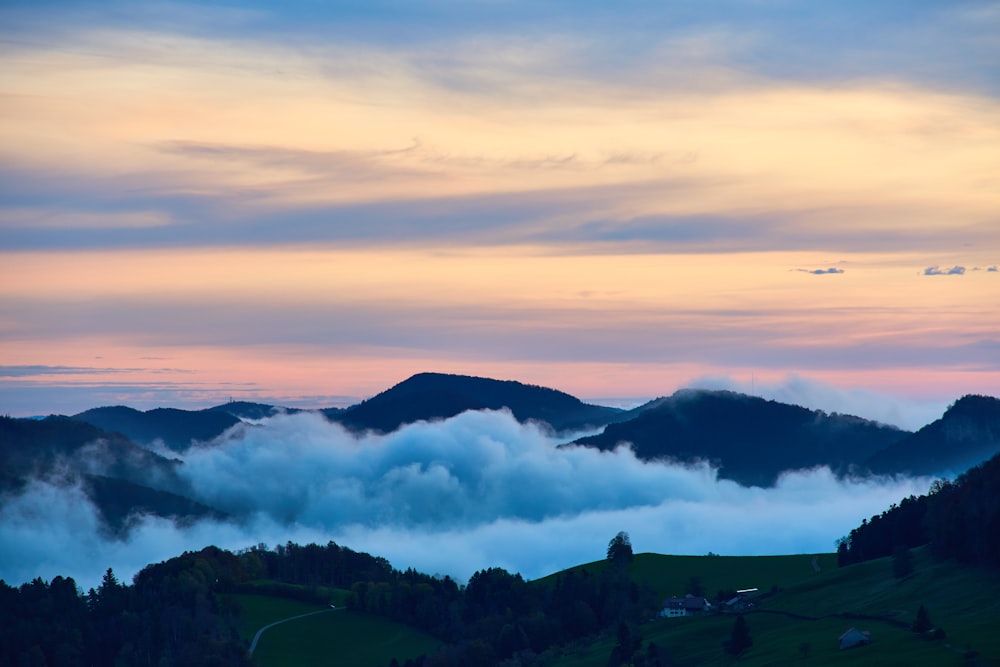 a view of a mountain range covered in clouds