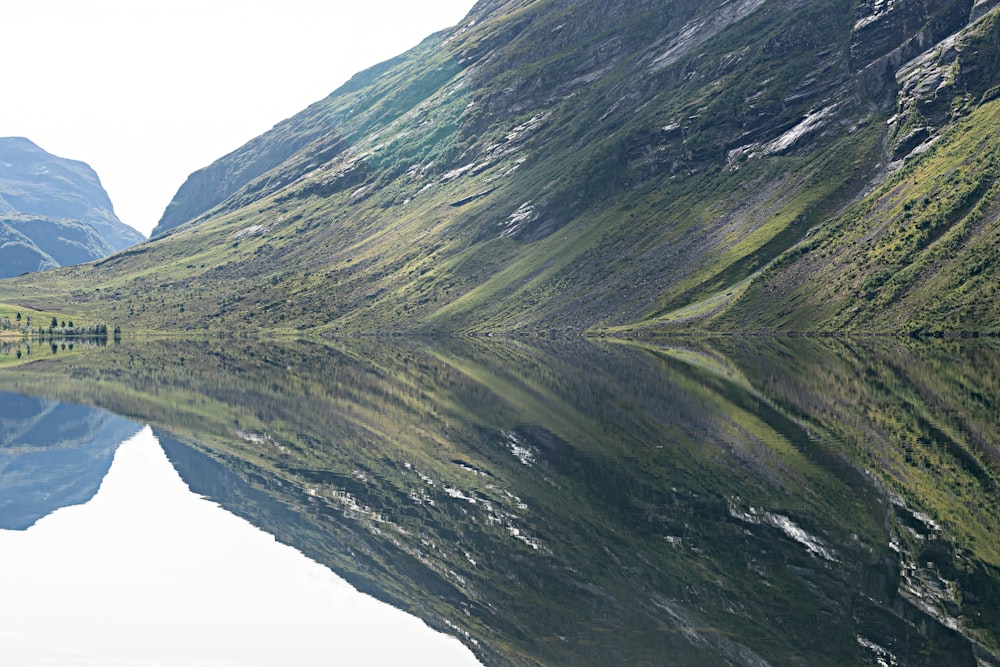 a mountain range with a body of water in the foreground