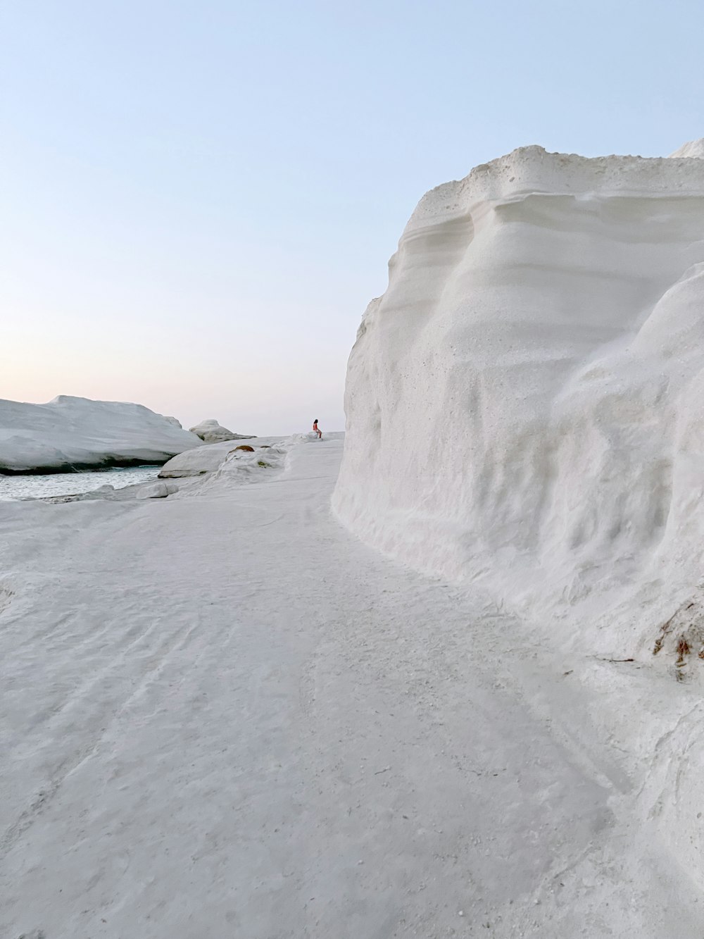 a person standing on top of a snow covered hill