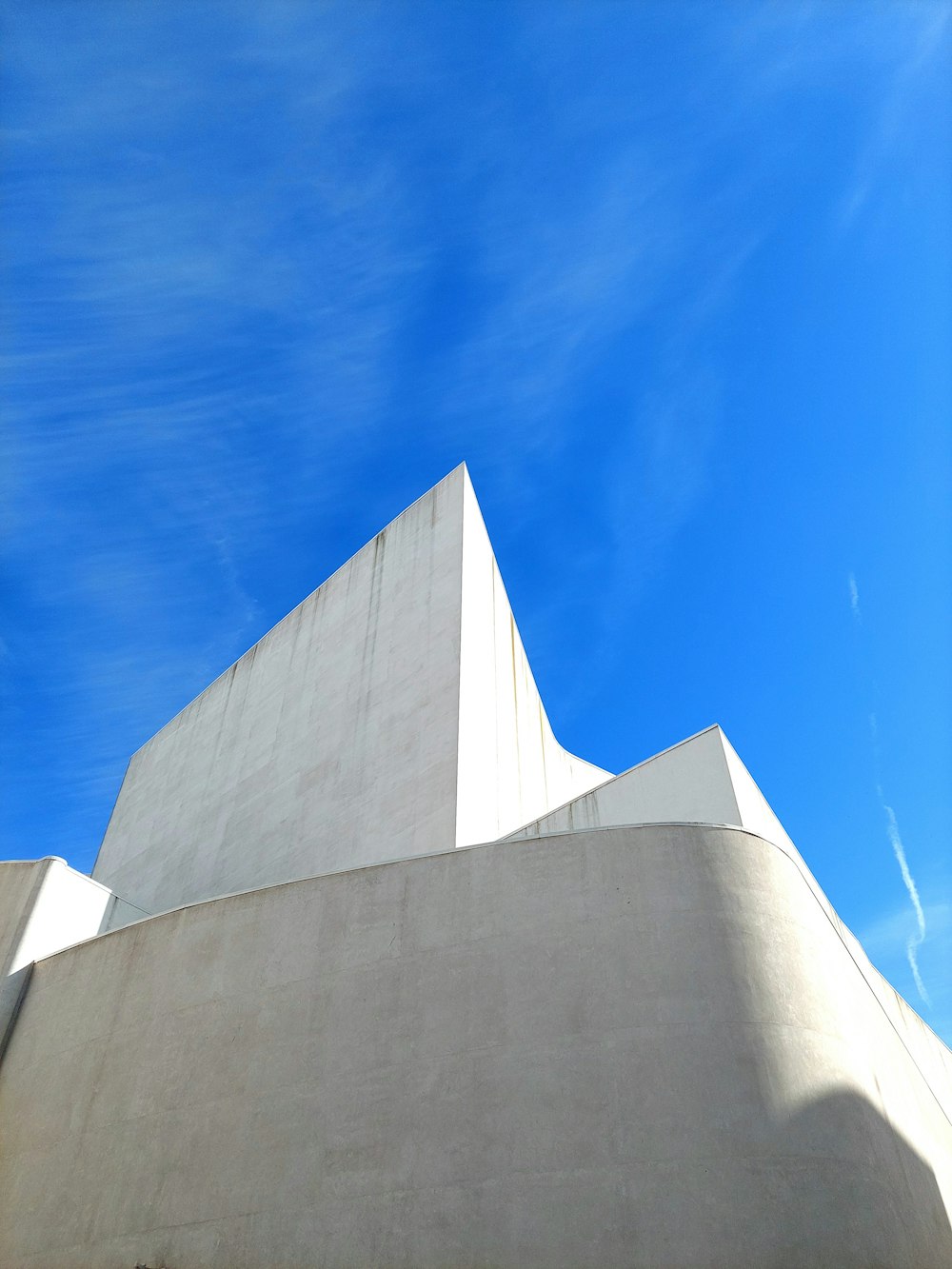 a white building with a blue sky in the background