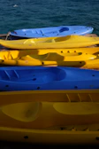 Colorful paddleboards lined up on the wooden dock ready for a day of adventure at Danau Biru Purwajaya