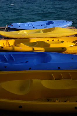 Colorful paddleboards lined up on the wooden dock ready for a day of adventure at Danau Biru Purwajaya