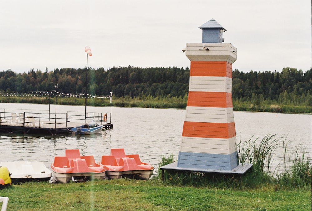 a light house sitting next to a body of water