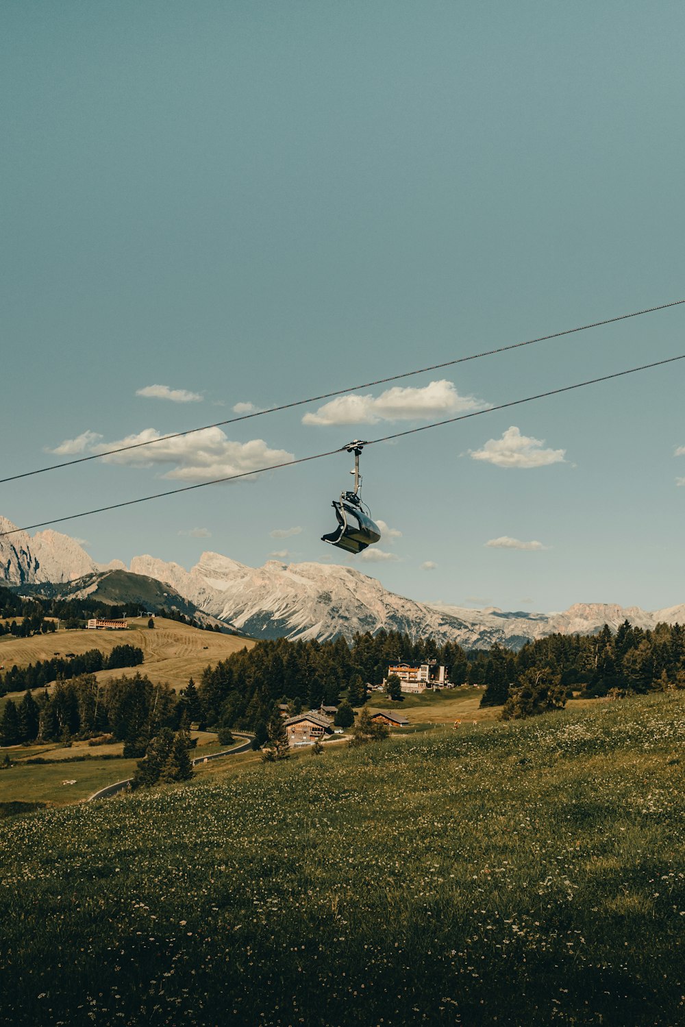 a person riding a zip line in the mountains