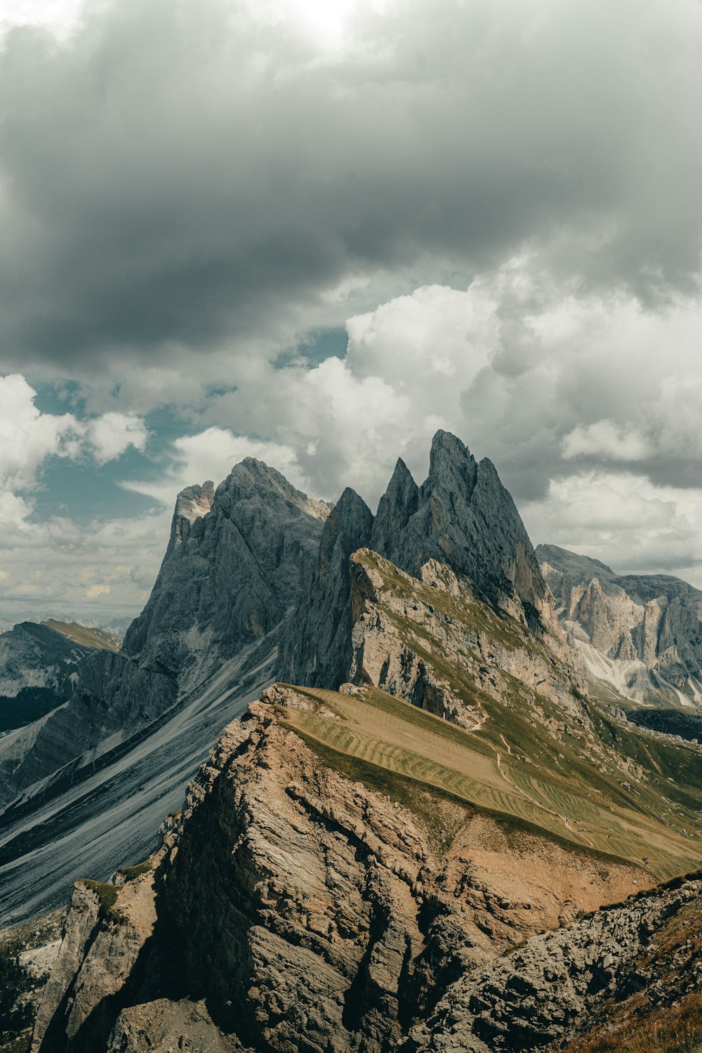 a mountain range under a cloudy sky