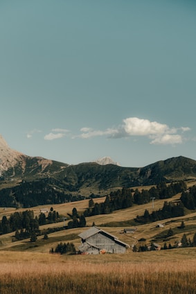 A picturesque farm with rolling hills and a rustic barn.