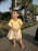 A joyful child wearing a colorful outfit, playing in a sunny park.
