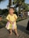 A happy toddler exploring outdoors in vibrant apparel, surrounded by nature.