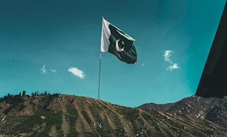 a flag flying on top of a mountain