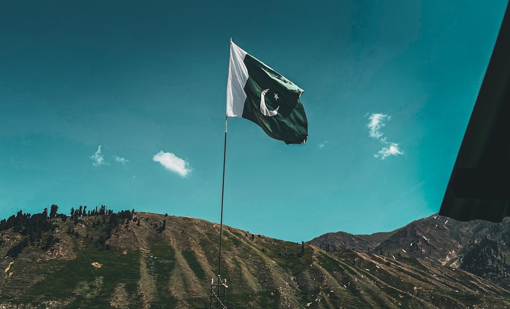 a flag flying on top of a mountain