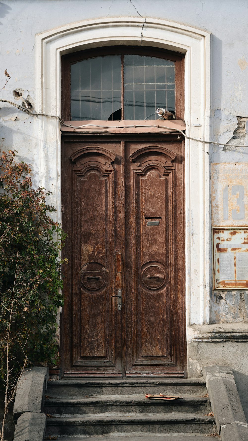 a large wooden door sitting next to a set of steps