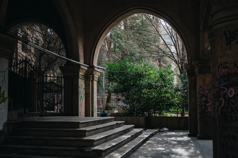 a set of steps leading to a tree lined courtyard