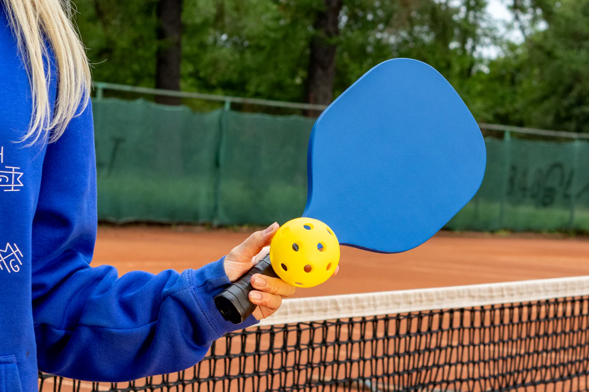 Pickleball paddles and balls on a court