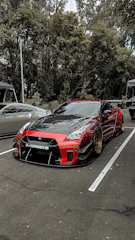 A sleek modified car with aggressive stance and glossy paint under sharp lighting.