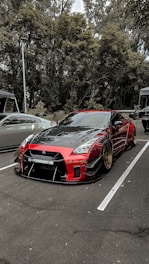 A sleek car parked in a scenic location, showcasing its stylish modifications.