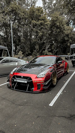 A sleek modified car with aggressive stance and glossy paint under sharp lighting.