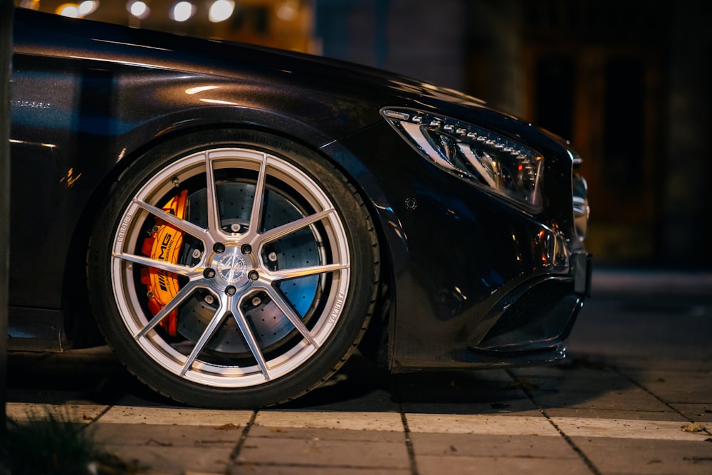 a close up of a car tire on a city street