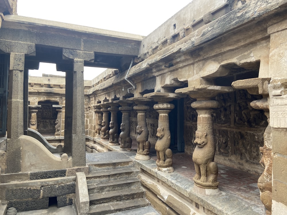 a row of stone statues in a building