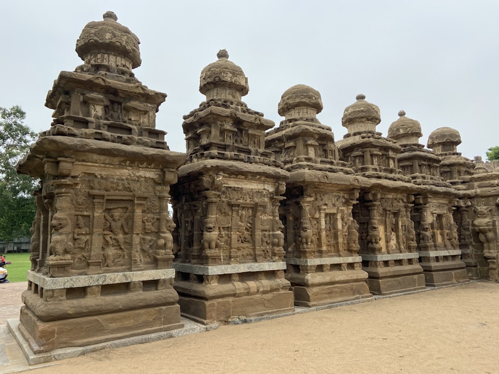 a row of stone sculptures in a park