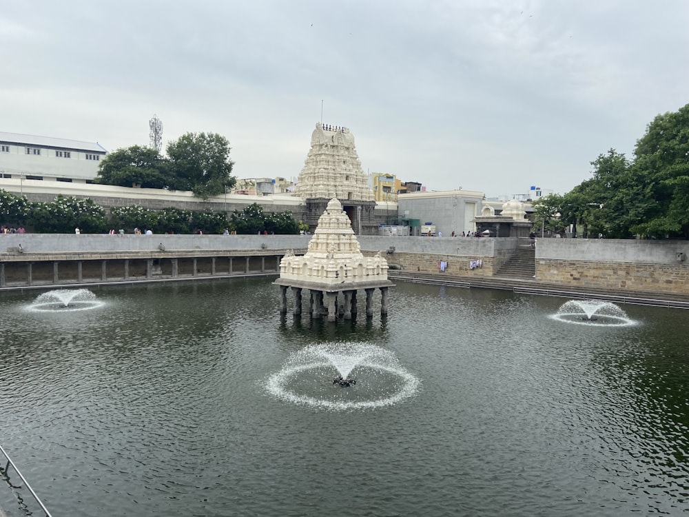 a pond with fountains in the middle of it