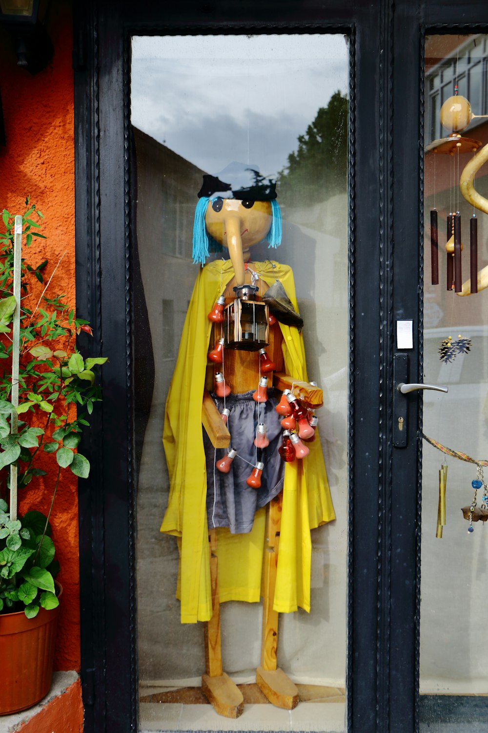 a mannequin dressed in a yellow raincoat