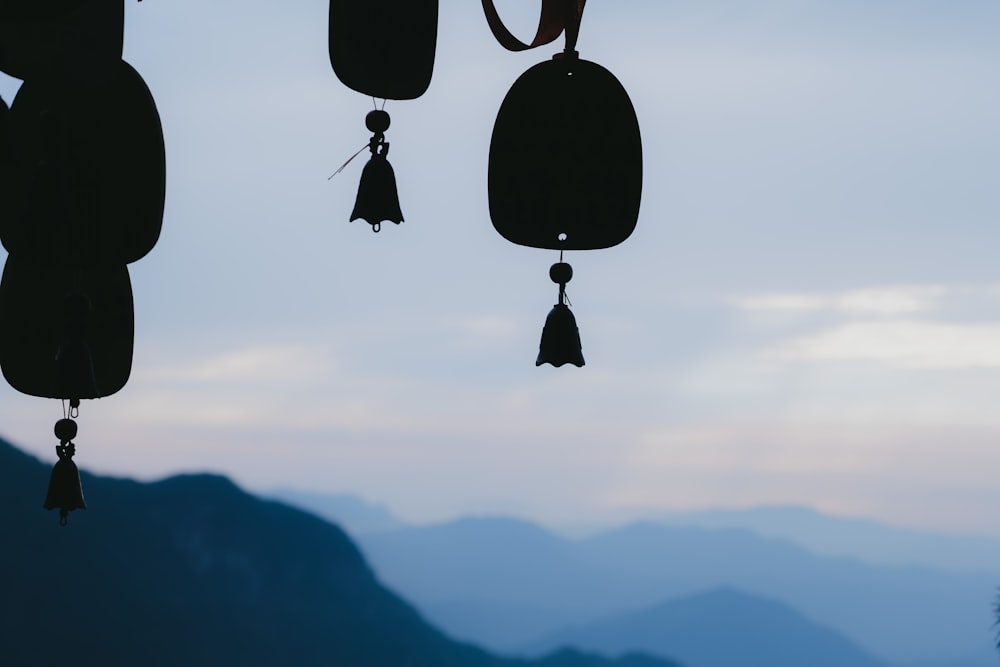 a group of bells hanging from the side of a mountain