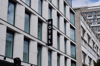 a hotel sign hanging from the side of a building