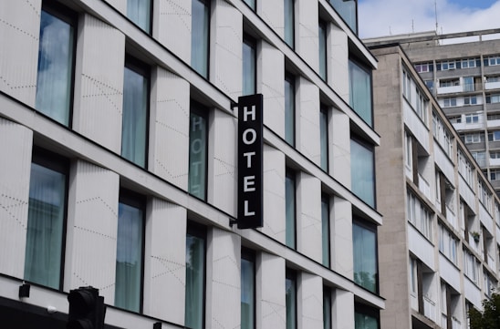 a hotel sign hanging from the side of a building