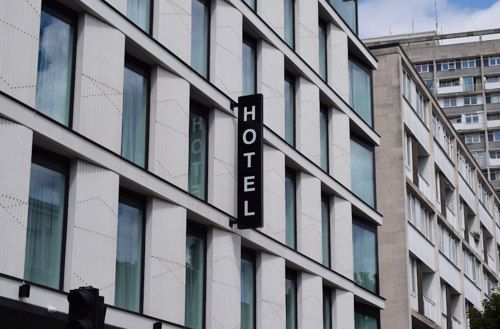 a hotel sign hanging from the side of a building