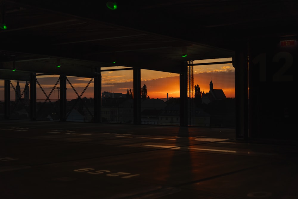 an empty parking lot with a sunset in the background