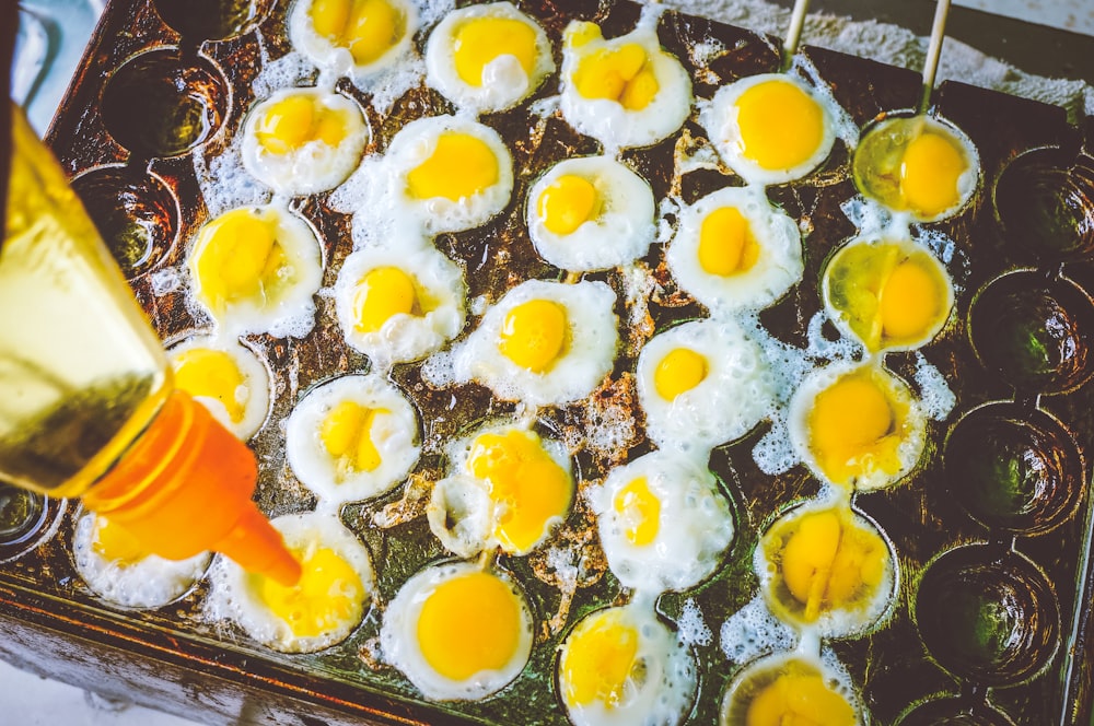 a tray filled with fried eggs on top of a table