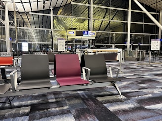 a row of chairs sitting next to each other in an airport