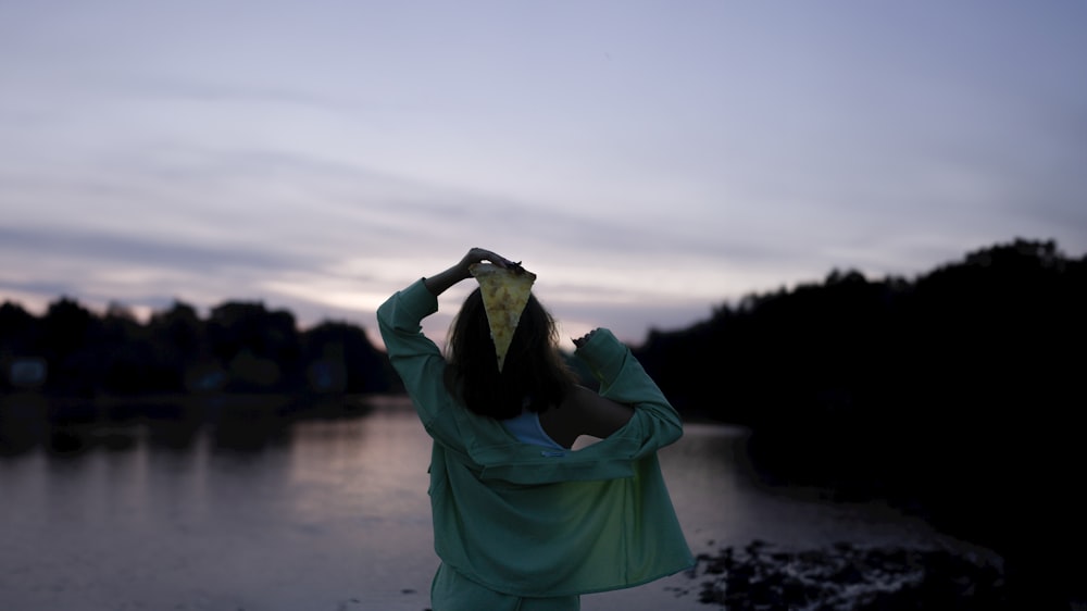 a woman with a bird's head covering her eyes