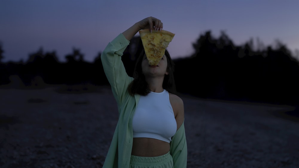 a woman with a piece of pizza on her head