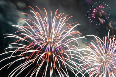 Person placing an order on a colorful fireworks website on a laptop.