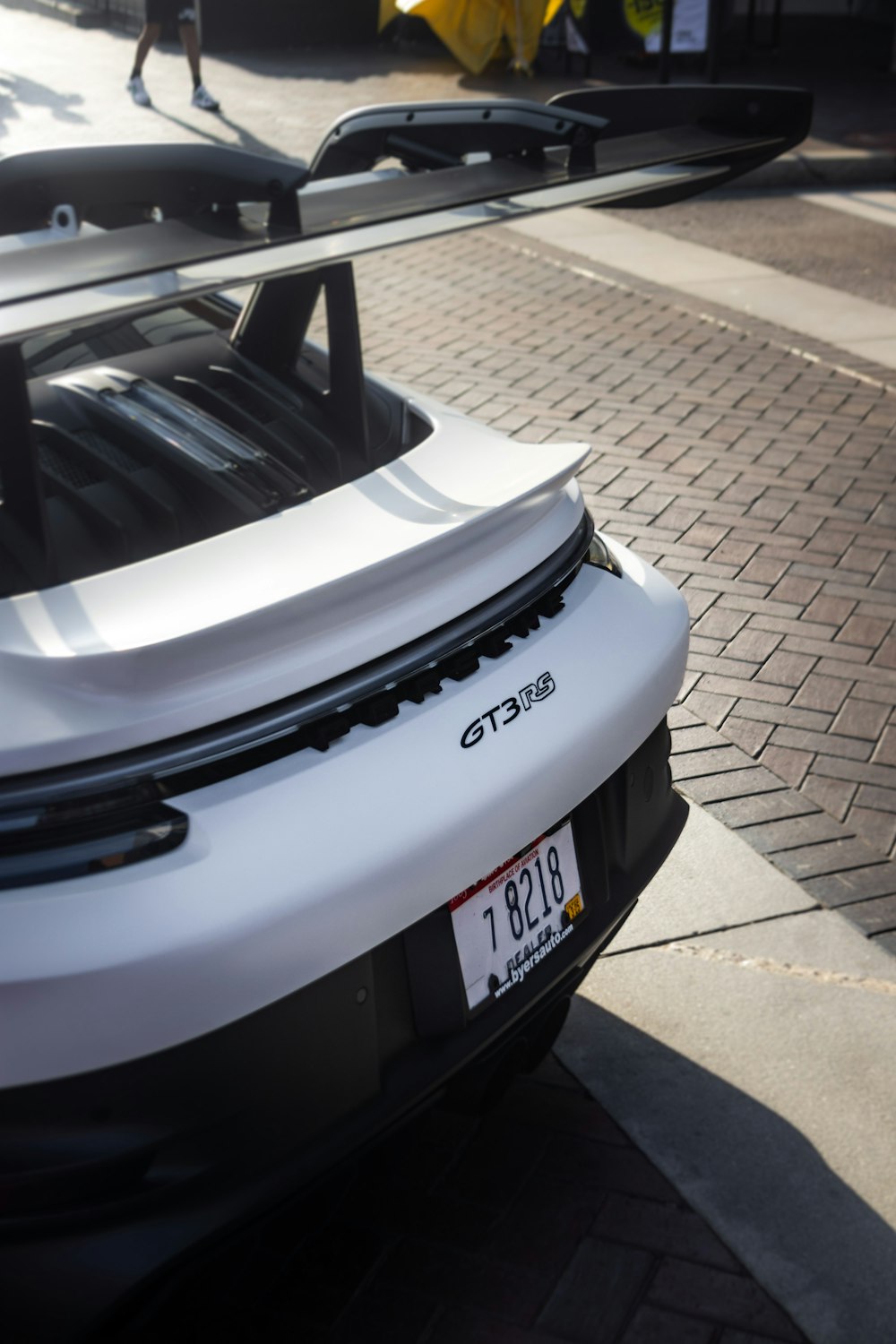 a white sports car parked on the side of the road