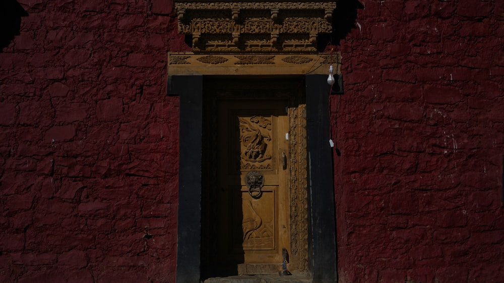 a yellow door in a red brick building