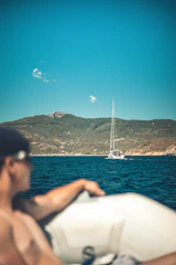 a man sitting on a boat in the water