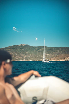a man sitting on a boat in the water