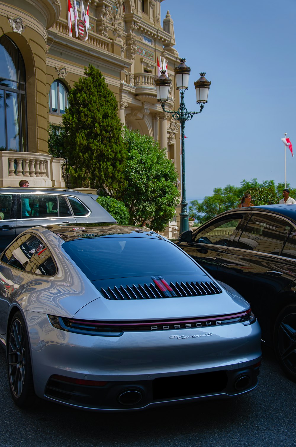 a silver car parked next to a black car