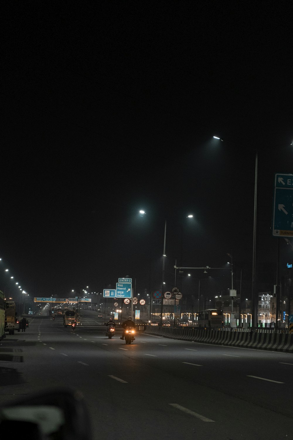 a car driving down a street at night