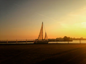 A serene sailboat gliding smoothly over calm waters at sunset, symbolizing reliable maintenance.